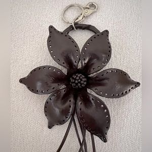 Handmade leather dark brown flower bag charm with silver color hardware.